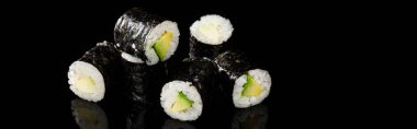 delicious sushi maki with avocado isolated on black, panoramic shot clipart