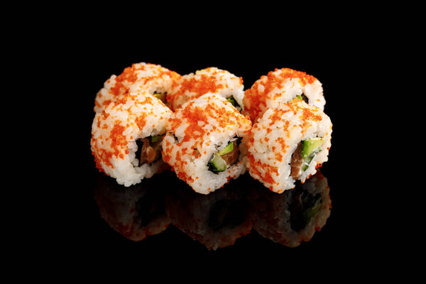 delicious California roll with avocado, salmon and masago caviar isolated on black