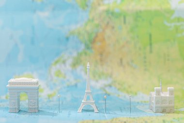 small figurines with city attractions on map of paris  clipart