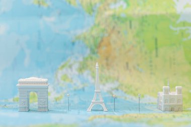 small figurines with city attractions on map of paris with pins  clipart