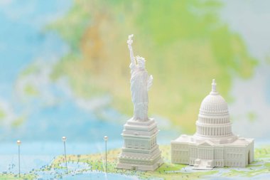 small figurines with american attractions on map with pins  clipart