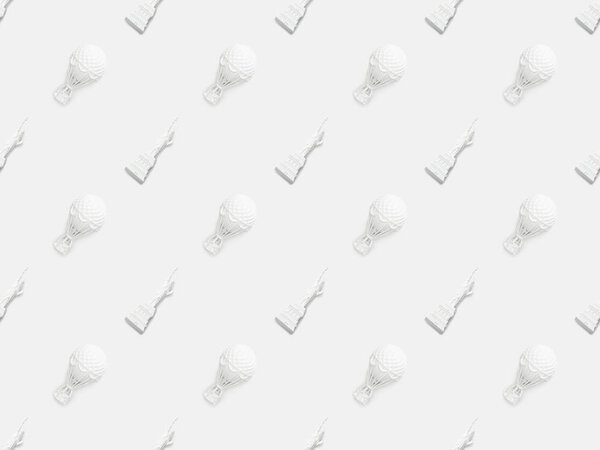 top view of small statue of liberty figurines and air balloons isolated on white 