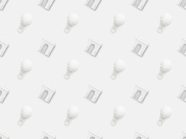 top view of small arc de triomphe and air balloons figurines isolated on white 