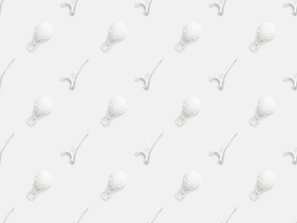 top view of eiffel tower statuettes and air balloons figurines isolated on white 