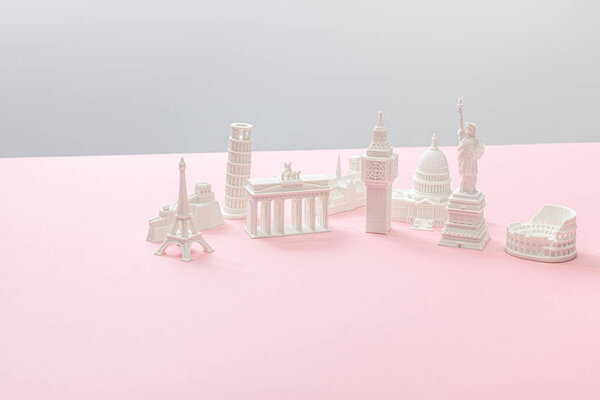 souvenirs from different countries on grey and pink 