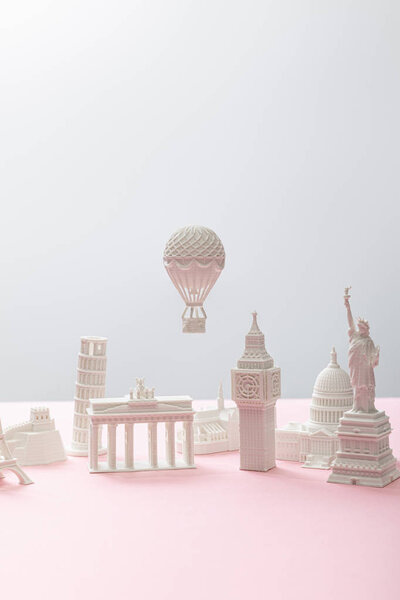 little souvenirs from different countries on grey and pink 