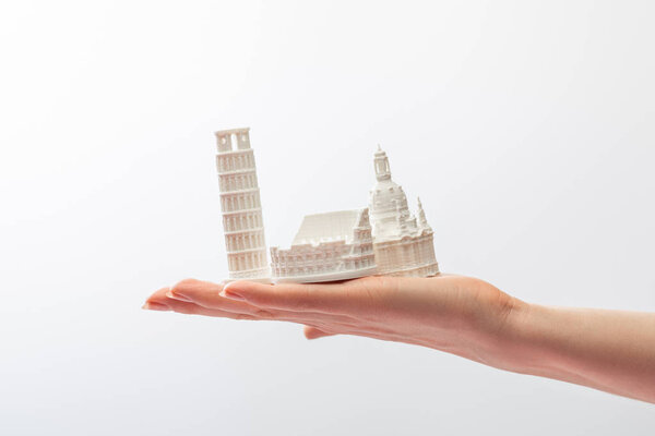 cropped view of girl holding small statuettes from italy isolated on white 