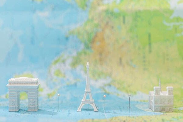 small figurines with city attractions on map of paris 