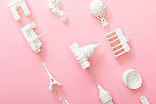 top view of figurines from countries on pink 
