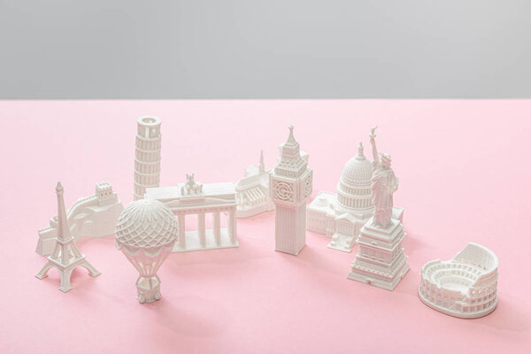 figurines from countries on pink and grey 