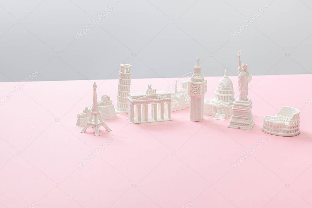 souvenirs from different countries on grey and pink 