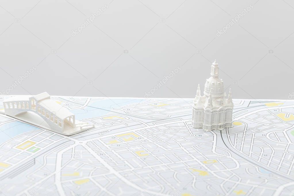 small figurines on map of italy isolated on grey  