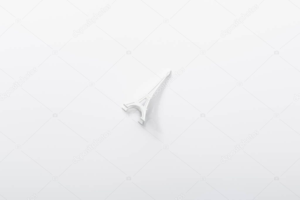 top view of small eiffel tower statuette isolated on white 