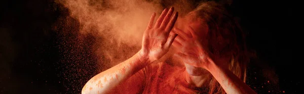 Woman Covering Face Orange Colorful Holi Paint Cloud Black Background — 스톡 사진