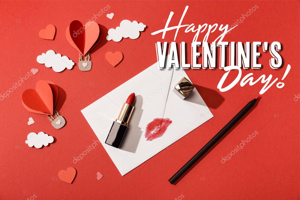 top view of heart shaped air balloons, lipstick and pencil near envelope with lip print and happy valentines day lettering on red background