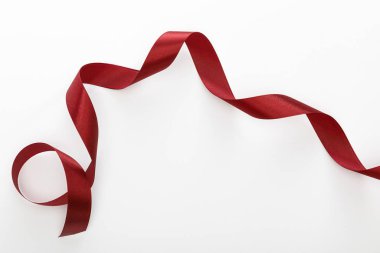 top view of satin burgundy decorative curved ribbon isolated on white clipart