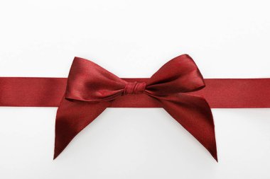 top view of satin burgundy decorative ribbon with bow isolated on white clipart