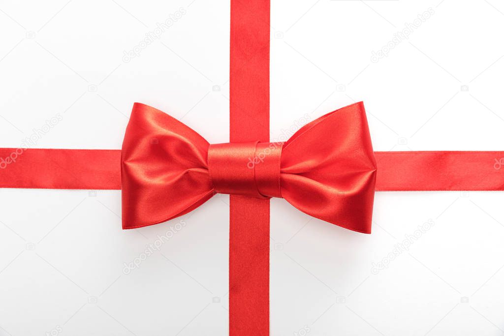 top view of red decorative ribbon with bow isolated on white