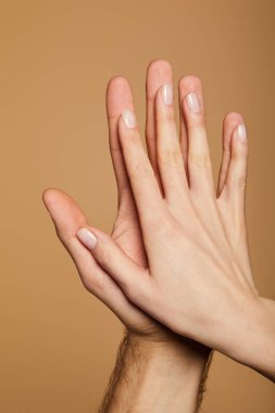 Kırpılmış bej üzerinde beşlik çakan kadın ve erkek manzarası
