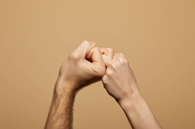 partial view of man and woman holding hands and fingers isolated on beige clipart