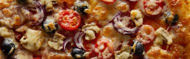 Top view of delicious pizza with cherry tomatoes, olives and parmesan, panoramic shot