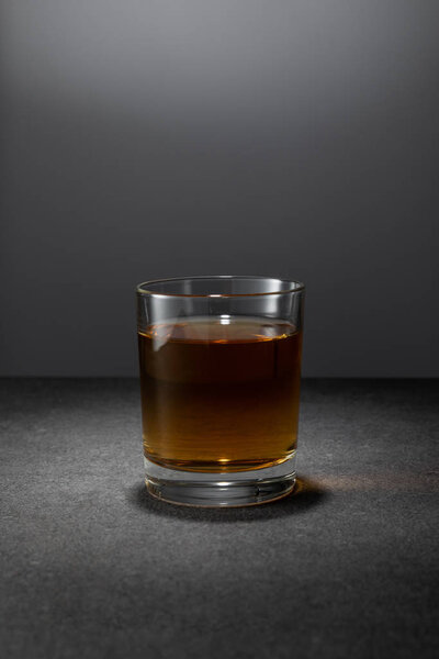 alcohol drink in glass on grey background 