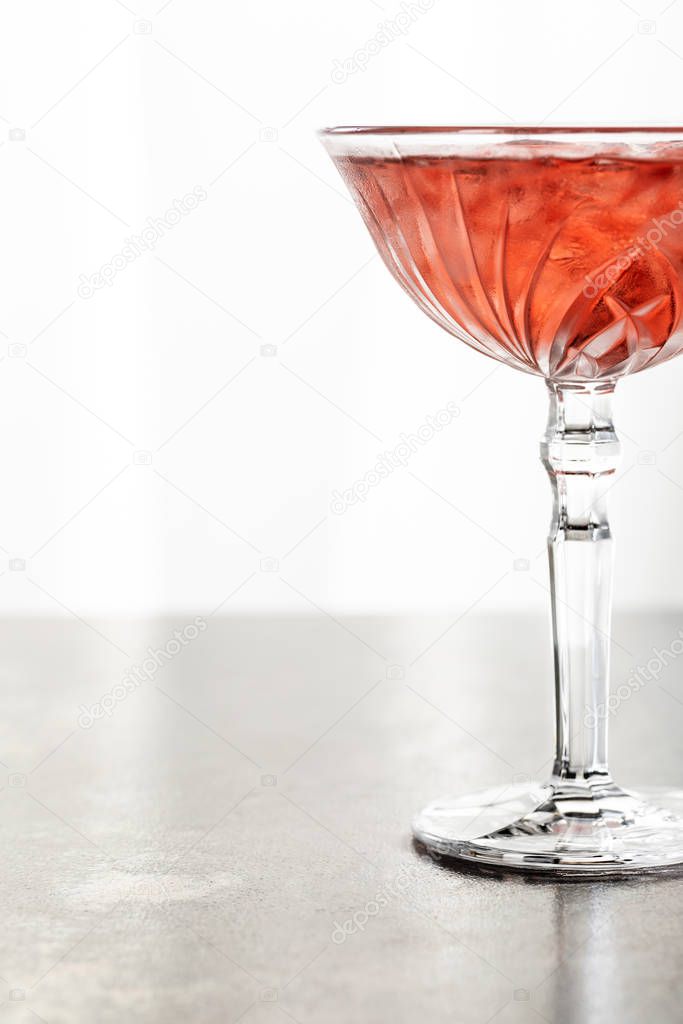  red cocktail with ice cubes in glass isolated on white 