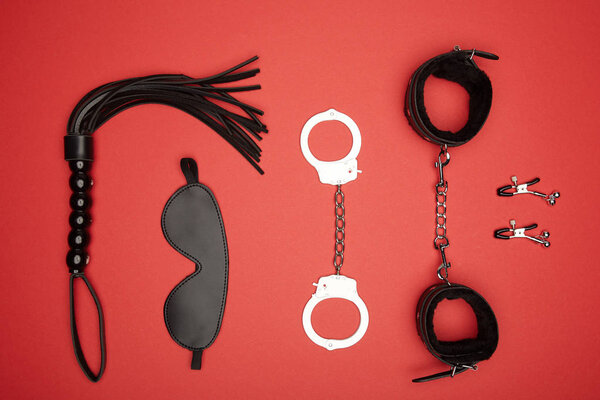 top view of various sex toys isolated on red