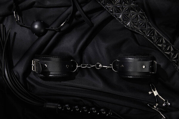 top view of sex toys on black textile background