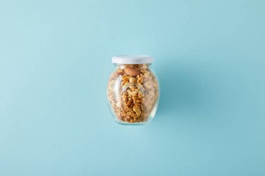 Top view of jar of granola on blue background clipart
