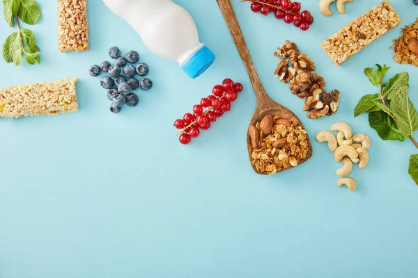 Top View Bottle Yogurt Berries Mint Nuts Cereal Bars Blue — Stock Photo, Image