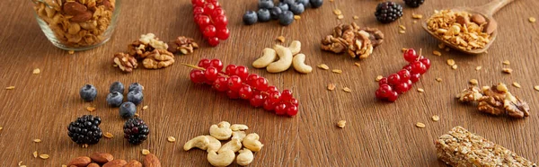 Blueberries Redcurrants Walnuts Almonds Cashews Cereal Bar Wooden Background Panoramic — Stock Photo, Image