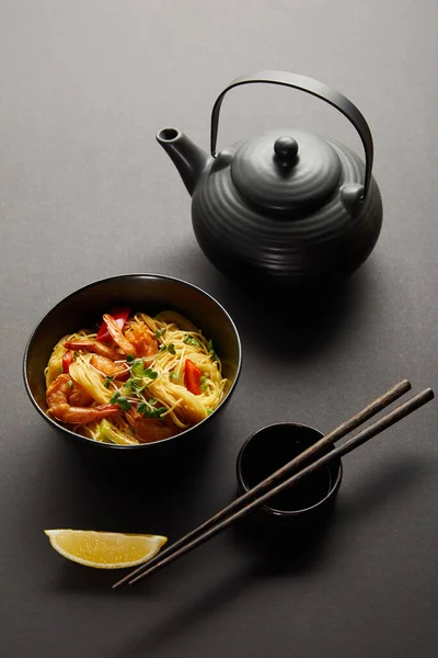 Noodles Shrimps Vegetables Bowl Lemon Teapot Wooden Chopsticks Soy Sauce — Stock Photo, Image