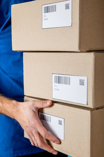 Cropped View Delivery Man Uniform Holding Cardboard Packages Codes Barcodes — Stock Photo, Image