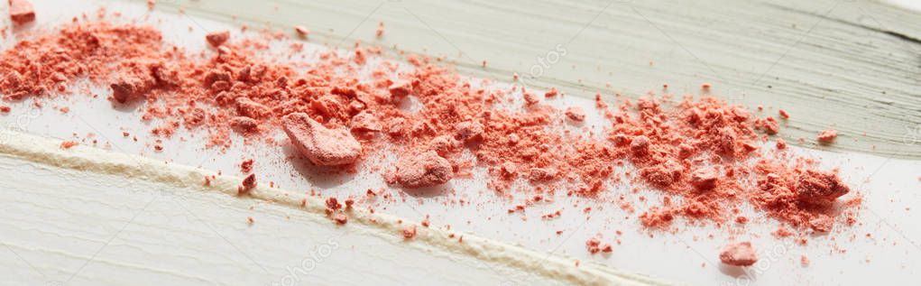 Tone cream and cosmetic clay brushstrokes with pink blusher on grey background, panoramic shot
