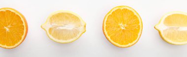 Top view of orange and lemon halves on white background, panoramic shot clipart