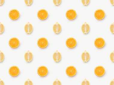 Top view of orange slices and lemons halves on white background clipart