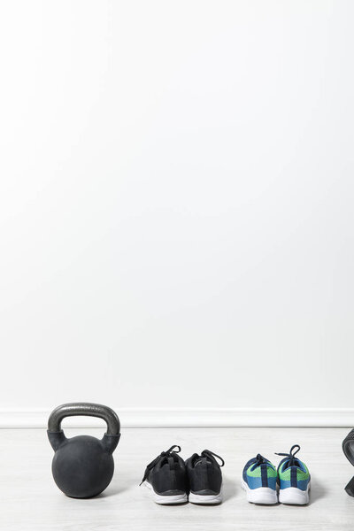 sport shoes and kettlebell on floor at home 