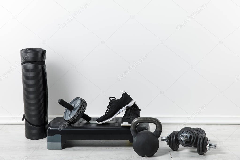 black fitness mats and sport equipment at home  