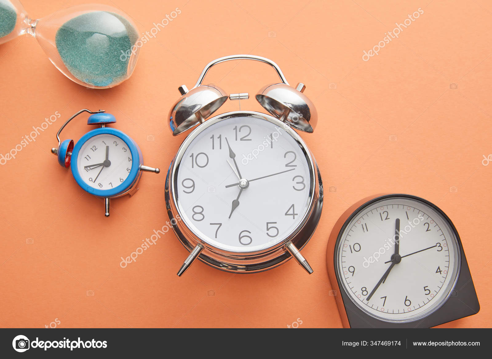 Top View Alarm Clocks Hourglass Peach Background Stock Photo by