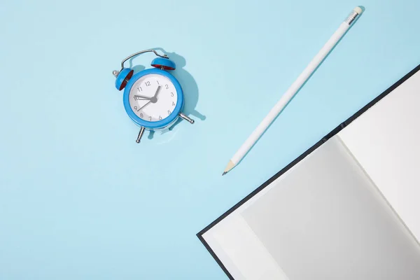 Top View Classic Alarm Clock Blank Netbook Pencil Blue Background — Stock Photo, Image