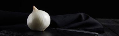 Siyah üzerine izole edilmiş siyah kesme tahtaları üzerine beyaz soğanın panoramik görüntüsü 
