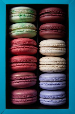 top view of assorted delicious colorful french macaroons in box clipart