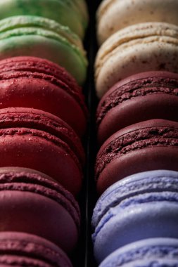 close up view of assorted delicious colorful french macaroons clipart