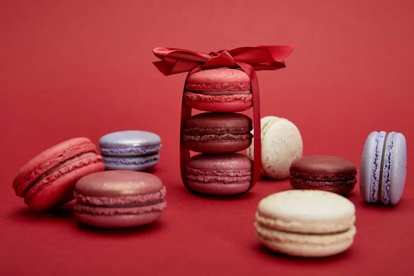 Assorted Delicious Colorful French Macaroons Bow Red Background — Stock Photo, Image