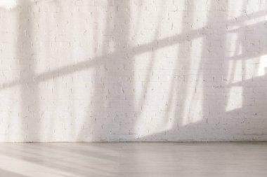 sunlight and shadows on brick wall in empty yoga studio  clipart