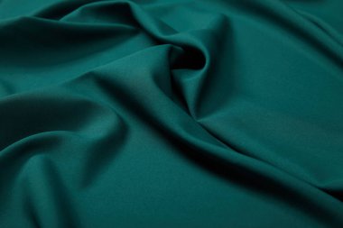 close up view of emerald soft and wavy silk fabric clipart