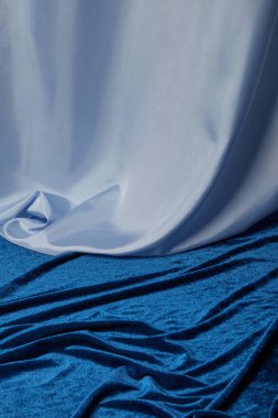 close up view of blue soft and crumpled silk and velour textured cloth clipart