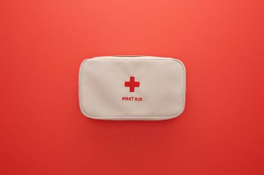 Top view of first aid kit isolated on red clipart