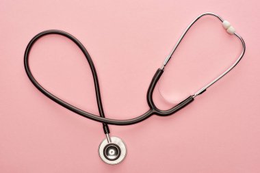 Top view of stethoscope on pink background  clipart